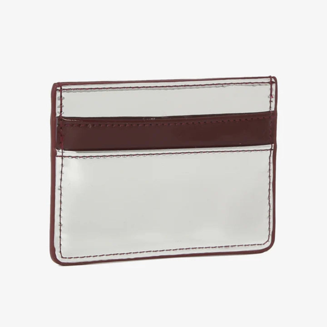 A minimalist card holder or credit card case made of glossy silver leather with a contrasting maroon horizontal band and matching maroon border stitching, shown on a plain white background.