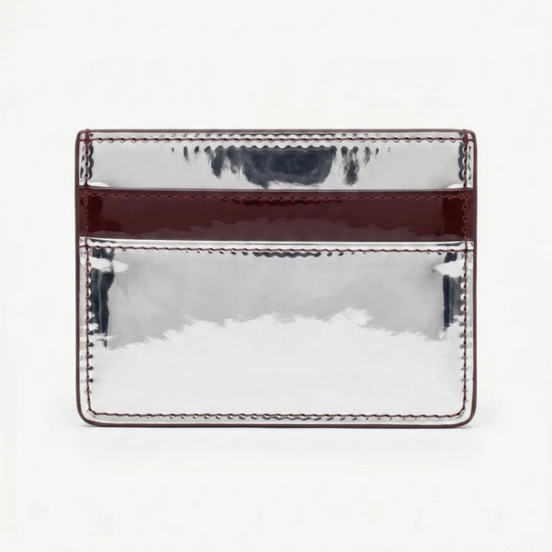 A rectangular metallic silver card holder with a glossy dark burgundy horizontal band and matching stitched edges, shown against a plain white background.