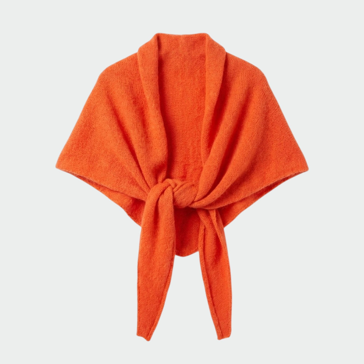A bright orange knit wrap  scarf tied at the front, displayed against a light gray background.